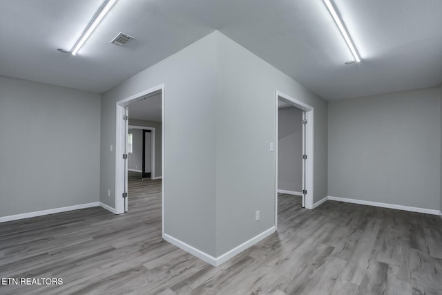 unfurnished room with light hardwood / wood-style floors