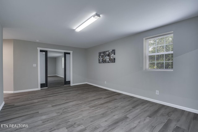 spare room with wood-type flooring