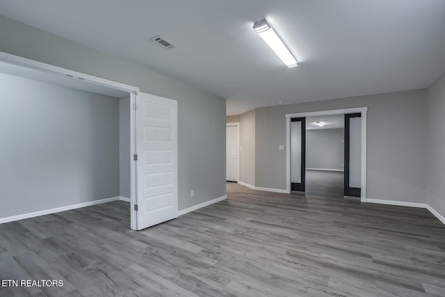 empty room with wood-type flooring