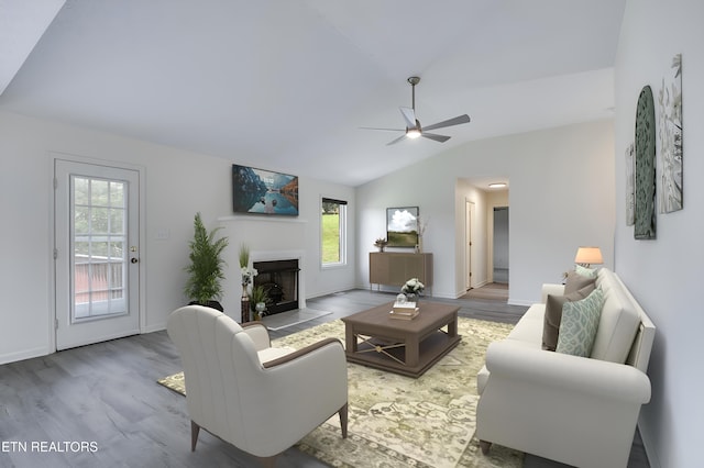 living room featuring ceiling fan, a wealth of natural light, lofted ceiling, and hardwood / wood-style flooring