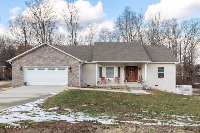 ranch-style home with covered porch, a garage, and a yard