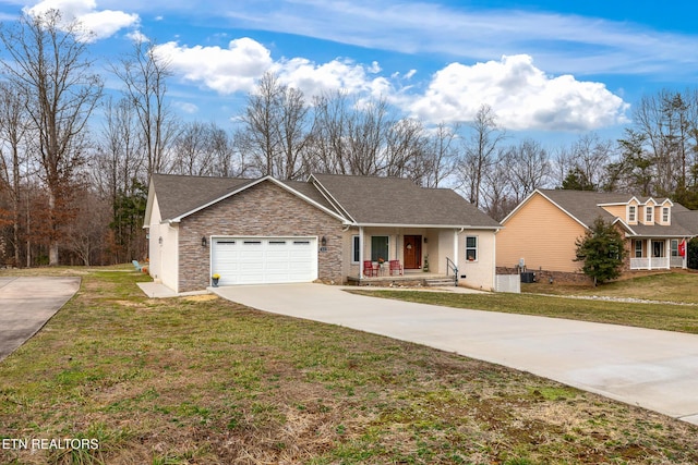 single story home featuring cooling unit, a porch, a garage, and a front yard