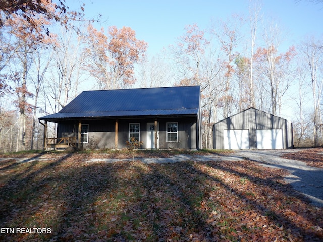 view of front of house with a porch, a garage, and an outdoor structure