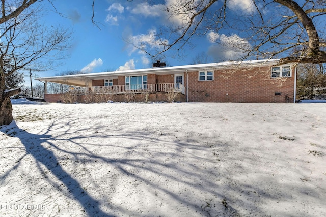 snow covered house with a porch