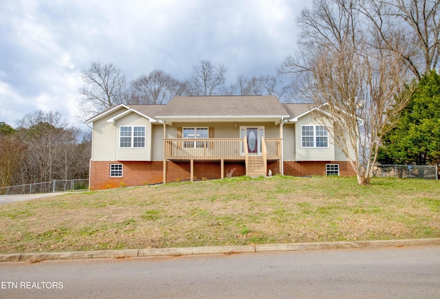 split foyer home featuring covered porch and a front lawn