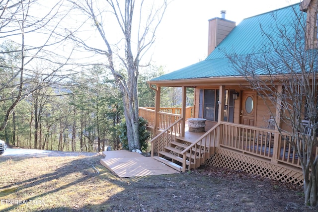 view of property exterior with a wooden deck