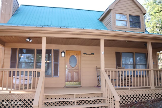 view of exterior entry with covered porch