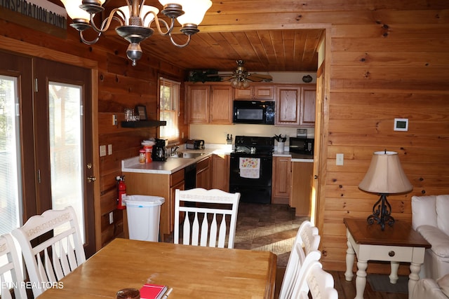 kitchen featuring wood walls, black appliances, wood ceiling, ceiling fan with notable chandelier, and sink