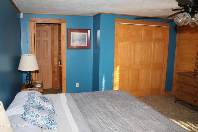 carpeted bedroom featuring ceiling fan, ornamental molding, and a textured ceiling