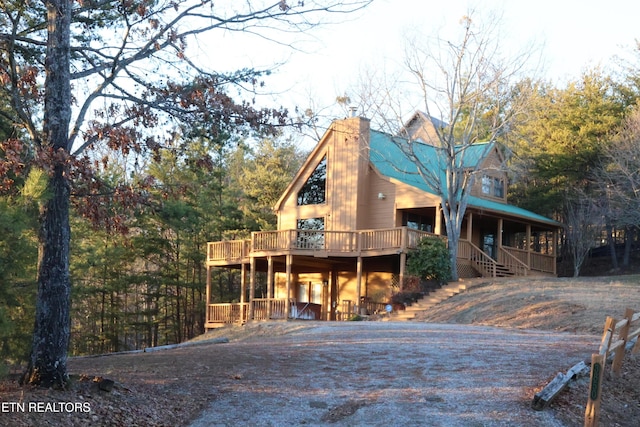 log-style house featuring a wooden deck