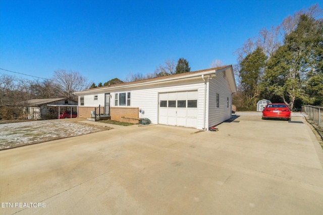 view of front facade with a shed and a garage