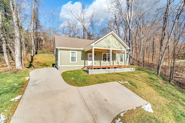 view of front of home with covered porch and a front yard