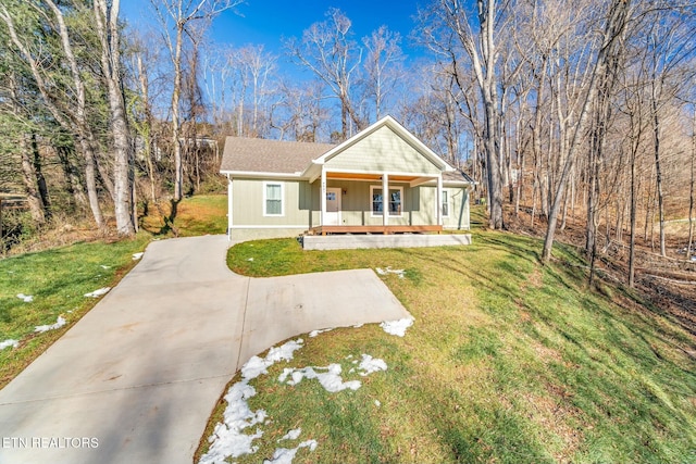 view of front of home with a porch and a front lawn