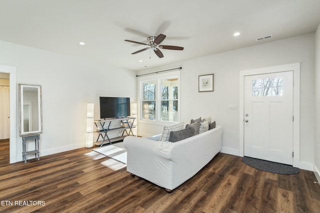 living room with ceiling fan and dark hardwood / wood-style floors