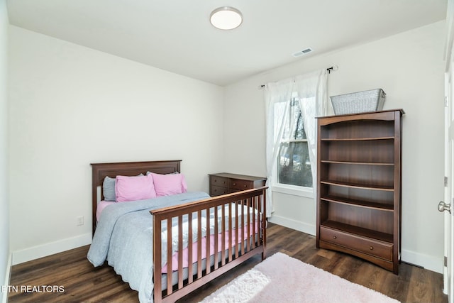 bedroom featuring dark hardwood / wood-style flooring