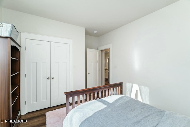 bedroom with a closet and dark hardwood / wood-style flooring