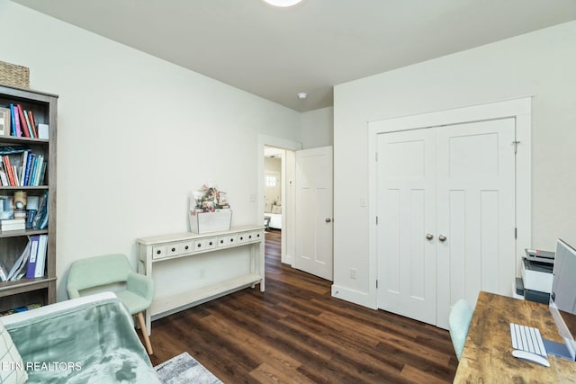 sitting room with dark wood-type flooring