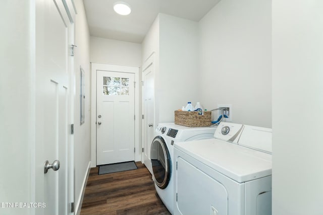 laundry area with dark hardwood / wood-style flooring and washer and clothes dryer