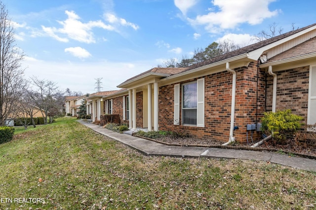 view of side of home with a yard