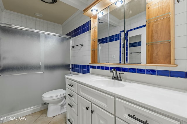 bathroom featuring tile patterned flooring, toilet, vanity, decorative backsplash, and a shower with shower door