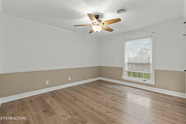 spare room with a textured ceiling, ceiling fan, crown molding, and light hardwood / wood-style flooring