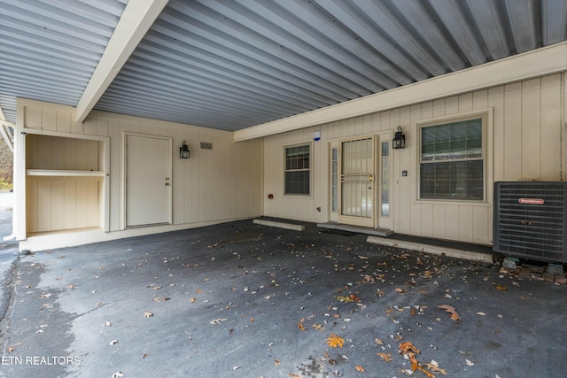 view of exterior entry with central AC unit