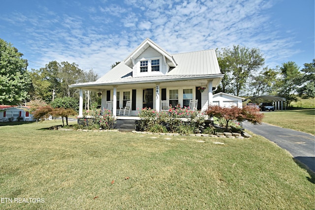 view of front facade with a front yard, covered porch, and a carport