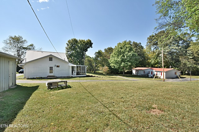 view of yard with a sunroom