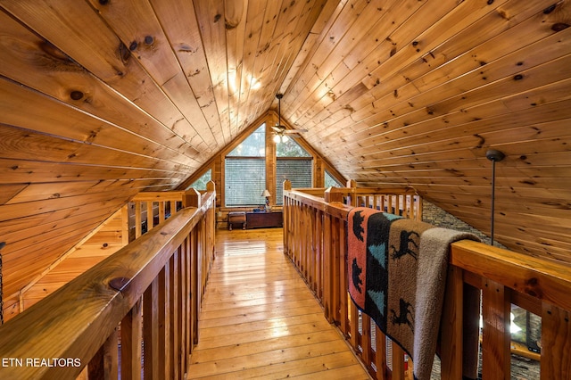 additional living space with wood ceiling, light hardwood / wood-style flooring, wooden walls, and lofted ceiling