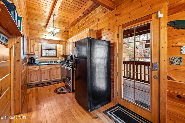 kitchen featuring black fridge, wooden walls, wooden ceiling, and beam ceiling