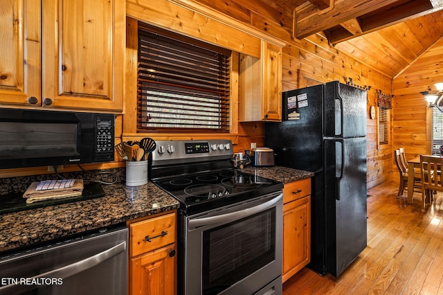 kitchen featuring wood ceiling, wood walls, black appliances, light wood-type flooring, and dark stone counters