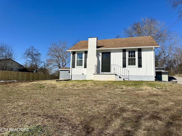 back of property with a lawn