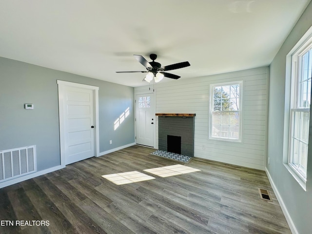 unfurnished living room featuring a brick fireplace, ceiling fan, and hardwood / wood-style flooring