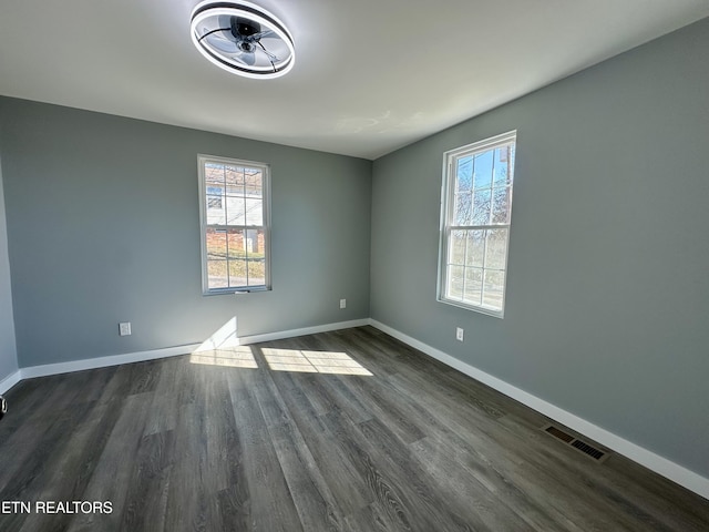 unfurnished room featuring ceiling fan and dark hardwood / wood-style flooring