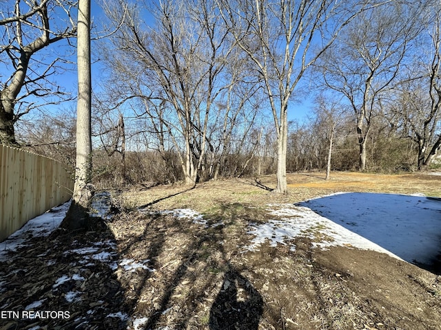 yard covered in snow with a patio area