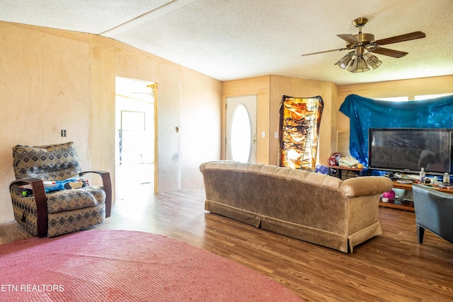 living room featuring lofted ceiling, a textured ceiling, ceiling fan, and hardwood / wood-style floors