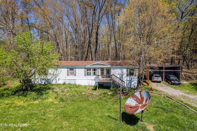 view of front facade featuring a front lawn and a carport