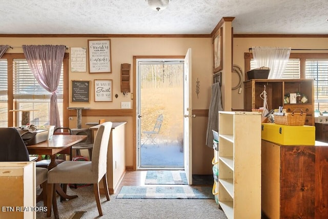 dining area featuring crown molding and a textured ceiling