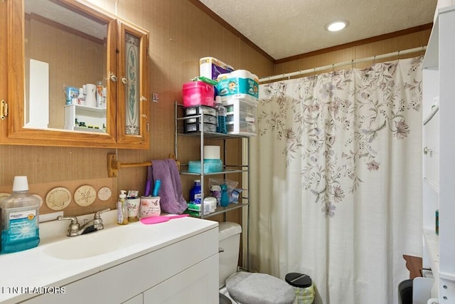 bathroom featuring curtained shower, a textured ceiling, vanity, toilet, and crown molding