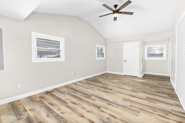 unfurnished bedroom with ceiling fan, lofted ceiling, and hardwood / wood-style floors