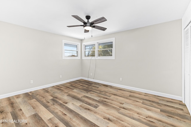 spare room featuring wood-type flooring and ceiling fan