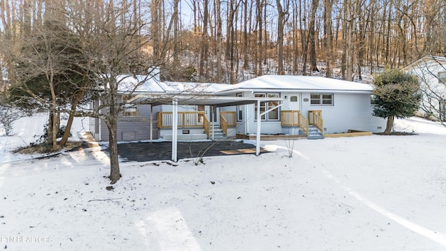 view of snow covered back of property