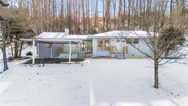 view of snow covered rear of property