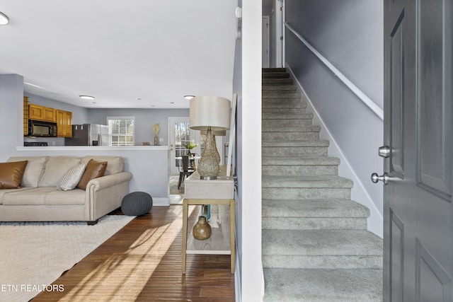 stairs featuring hardwood / wood-style flooring