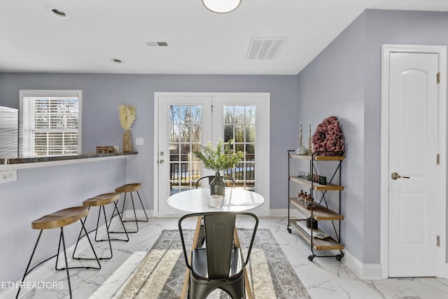 dining space featuring a wealth of natural light and french doors