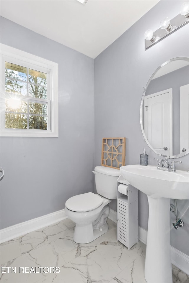 bathroom featuring toilet and sink