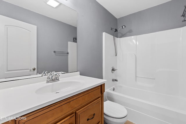 full bathroom featuring tub / shower combination, toilet, and vanity