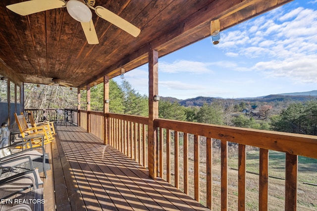 deck featuring ceiling fan and a mountain view