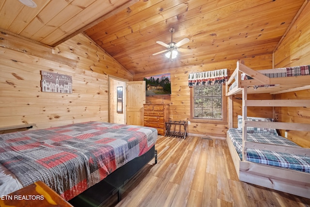 bedroom featuring vaulted ceiling, wooden ceiling, wood walls, and wood-type flooring