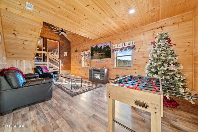 playroom with vaulted ceiling, wood walls, hardwood / wood-style floors, ceiling fan, and wooden ceiling